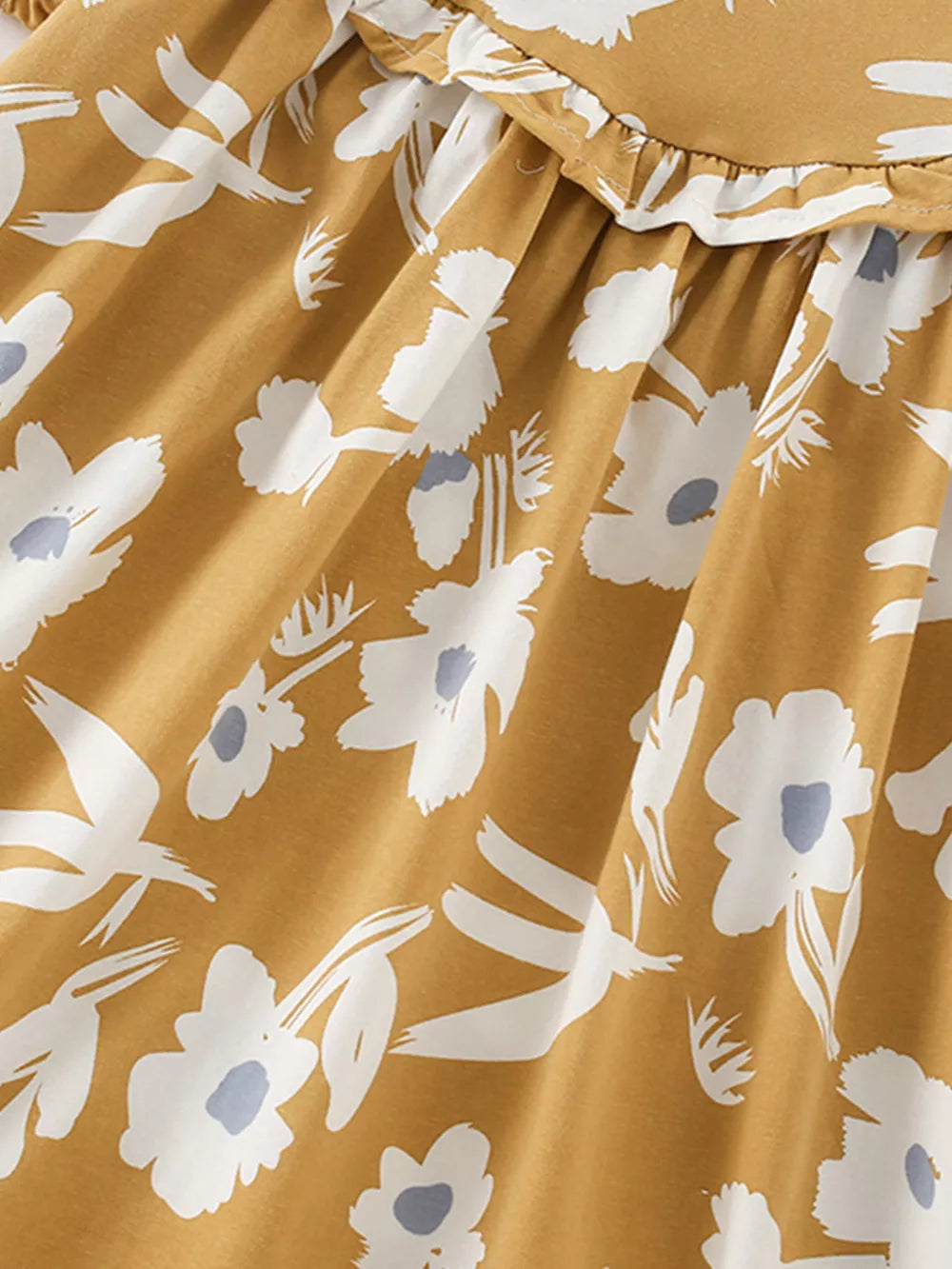 Toddler dress with white floral and bird print on mustard cotton blend, featuring a ruffled neckline.