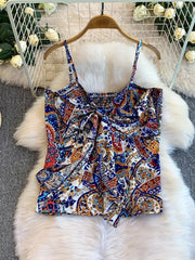 Chic paisley print cami with knot detail and smocked back in blue, rust, and white.
