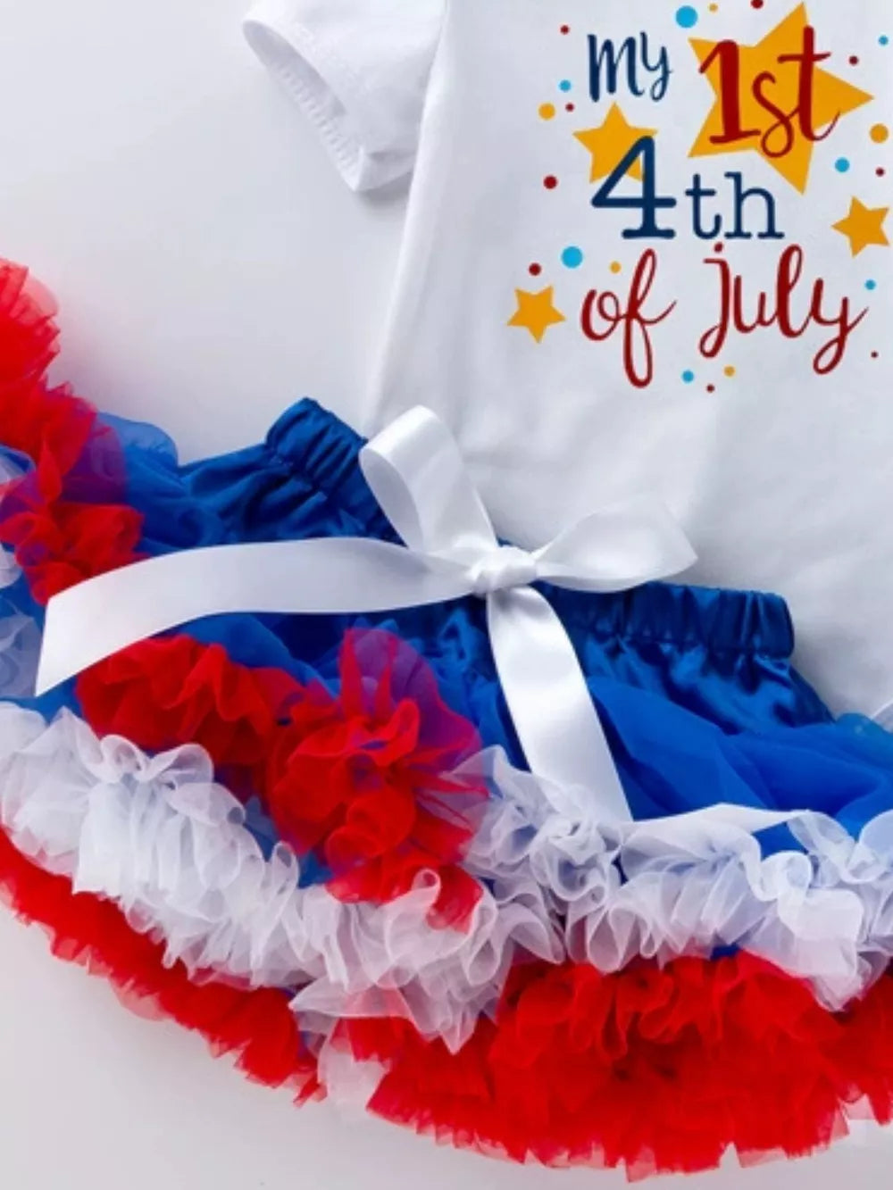 Baby patriotic outfit with ruffled tutu and 4th of July graphic tee.