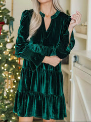 Dark green velvet tiered mini dress with smocked cuffs and notched neckline.