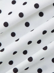 White t-shirt with black polka dots and ruched fabric detail.