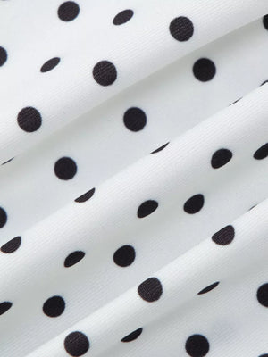 White t-shirt with black polka dots and ruched fabric detail.