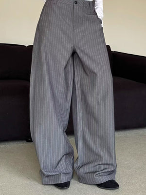 Men's grey pinstripe wide leg sweatpants with a relaxed fit.