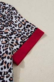 Leopard print polyester shirt with red cuffs and textured fabric.