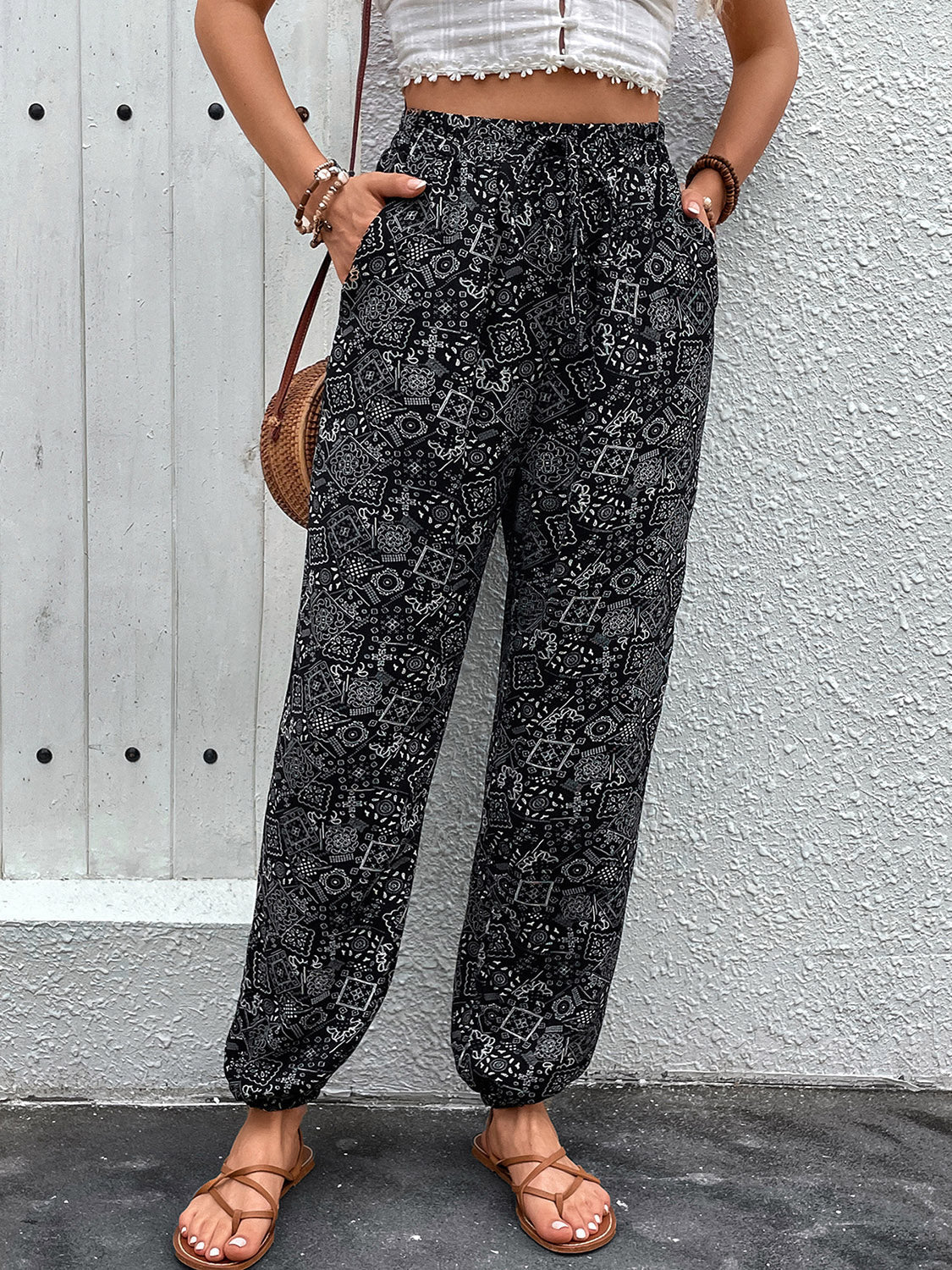 Black printed jogger trousers with gathered ankles and drawstring waist