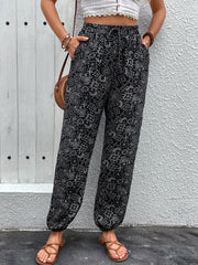 Black printed jogger trousers with gathered ankles and drawstring waist