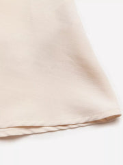 Cream A-line midi dress in polyester with pearl accents, showing hem detail.