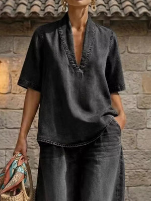 Black V-neck cotton top with wide-leg pants, curved hem, and cuffed ankles.