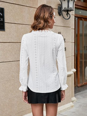 White eyelet blouse with floral embroidery and ruffle cuffs