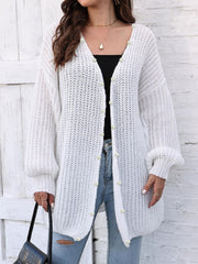 White balloon sleeve cardigan with pearl buttons and open knit detail.