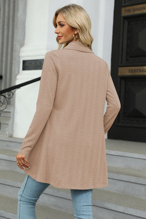 Tan cable knit cardigan with a drape front and long sleeves.