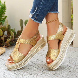 Gold crocodile-embossed platform sandals with adjustable buckle and espadrille trim.