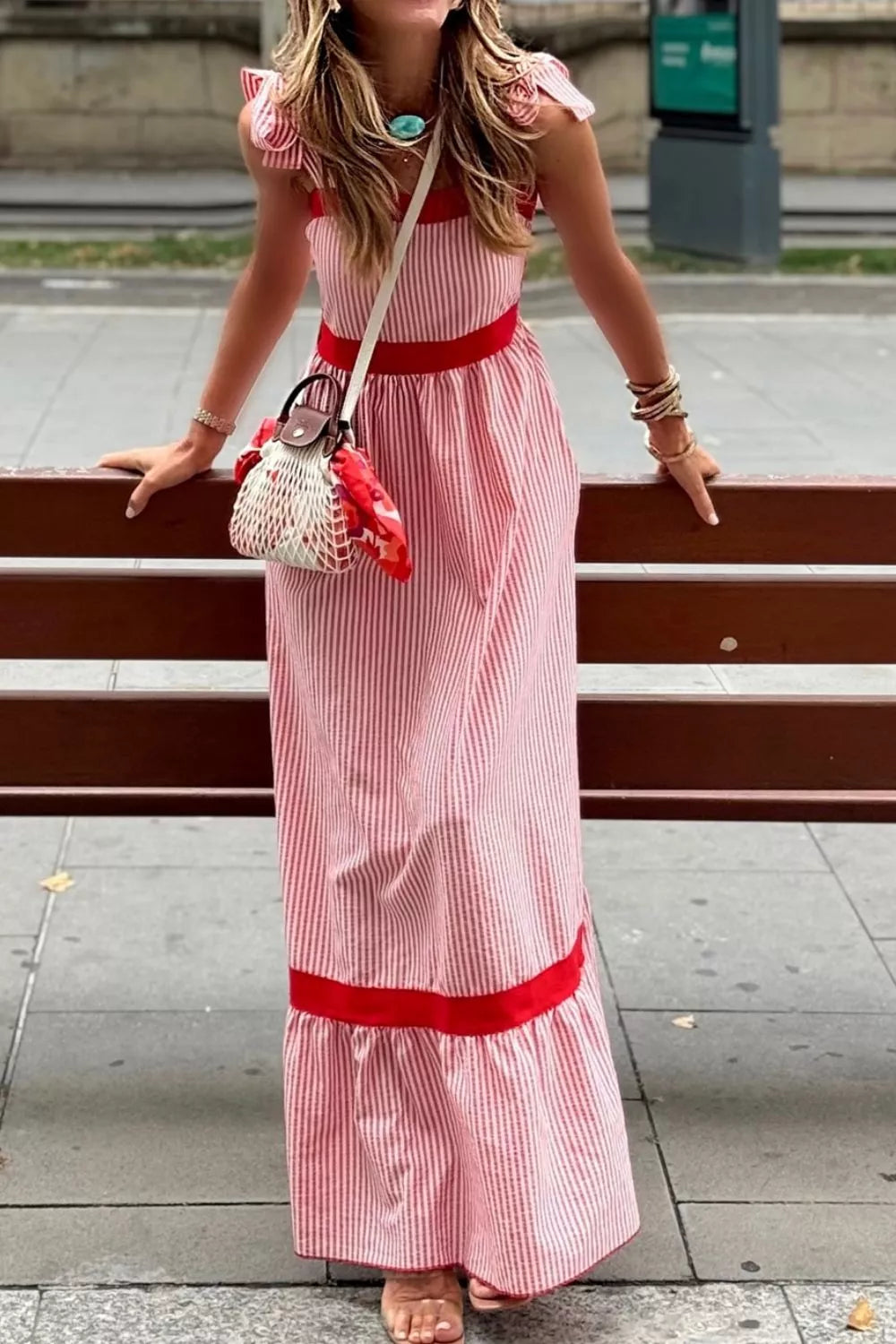 Maxi dress with red and white stripes, bow knot straps, and red trim.