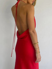 Red satin halter maxi dress with open back and body skimming fit.