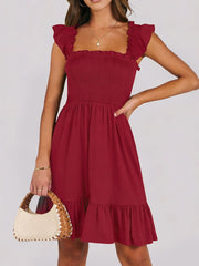 Burgundy smocked mini dress with ruffle hem and square neckline.