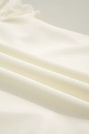 Cream cotton blouse with ruffles and stand-up collar detail