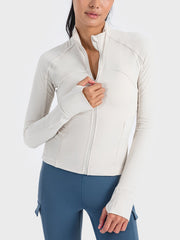 Ribbed white performance zip-up track jacket with thumbholes and mock neck.