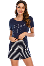 Navy graphic tee with "DREAM BIG" text and striped shorts.