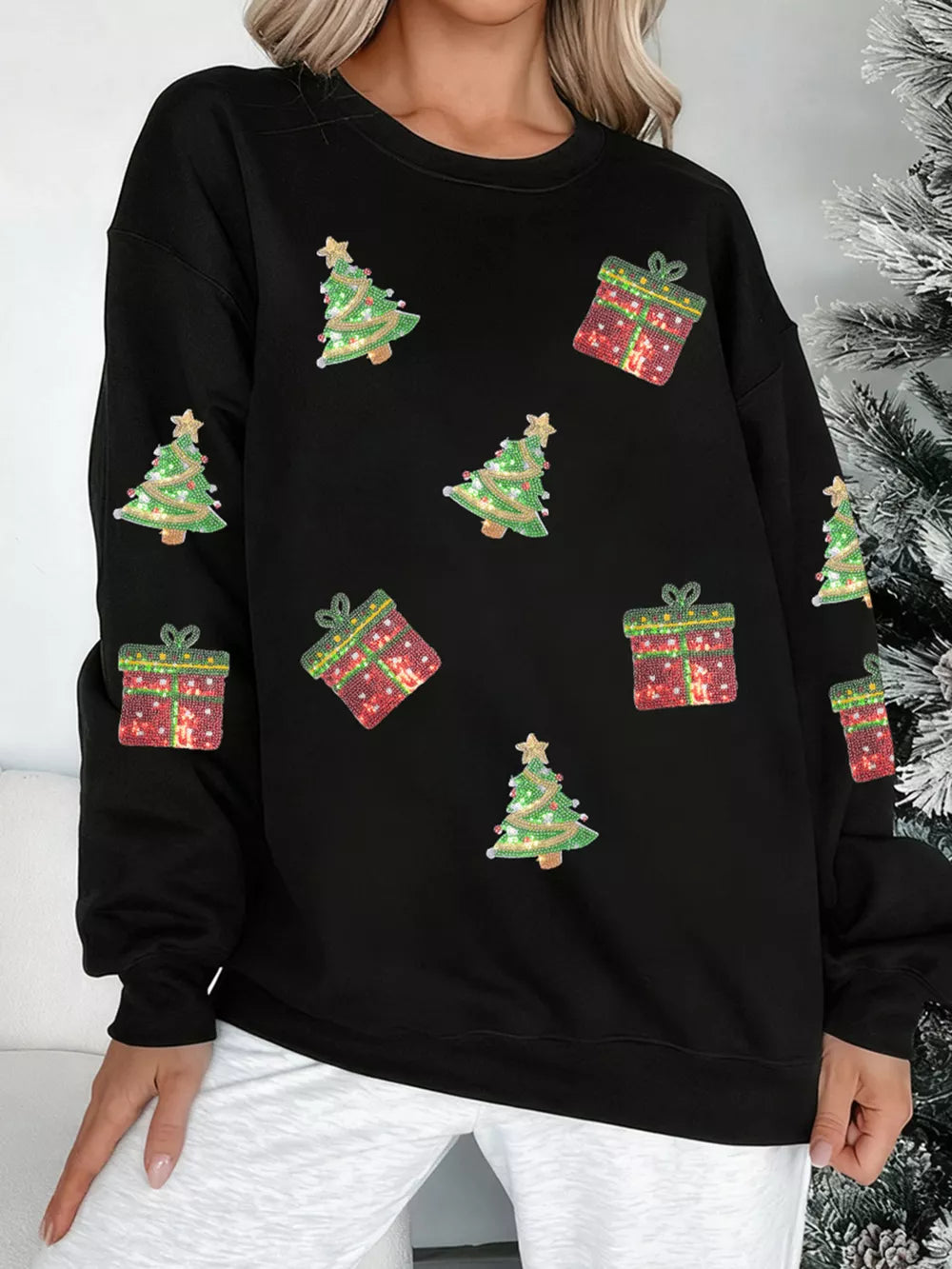Black cotton crew neck sweatshirt with sequin Christmas tree and gift embellishments.