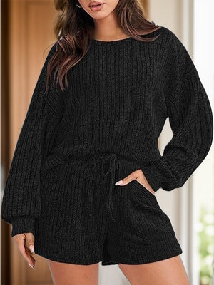 Black ribbed knit lounge set with crew neck, long sleeves, drawstring waist shorts and pockets.