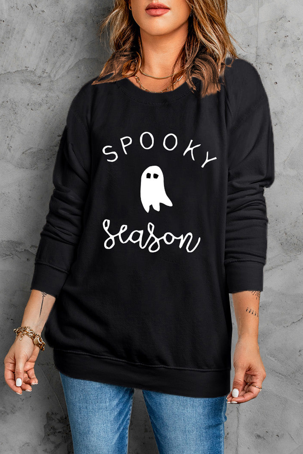 Black crewneck sweatshirt with white "Spooky Season" ghost graphic, casual fit.
