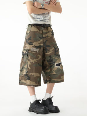 Men's distressed camo cargo shorts with patches and raw hem.