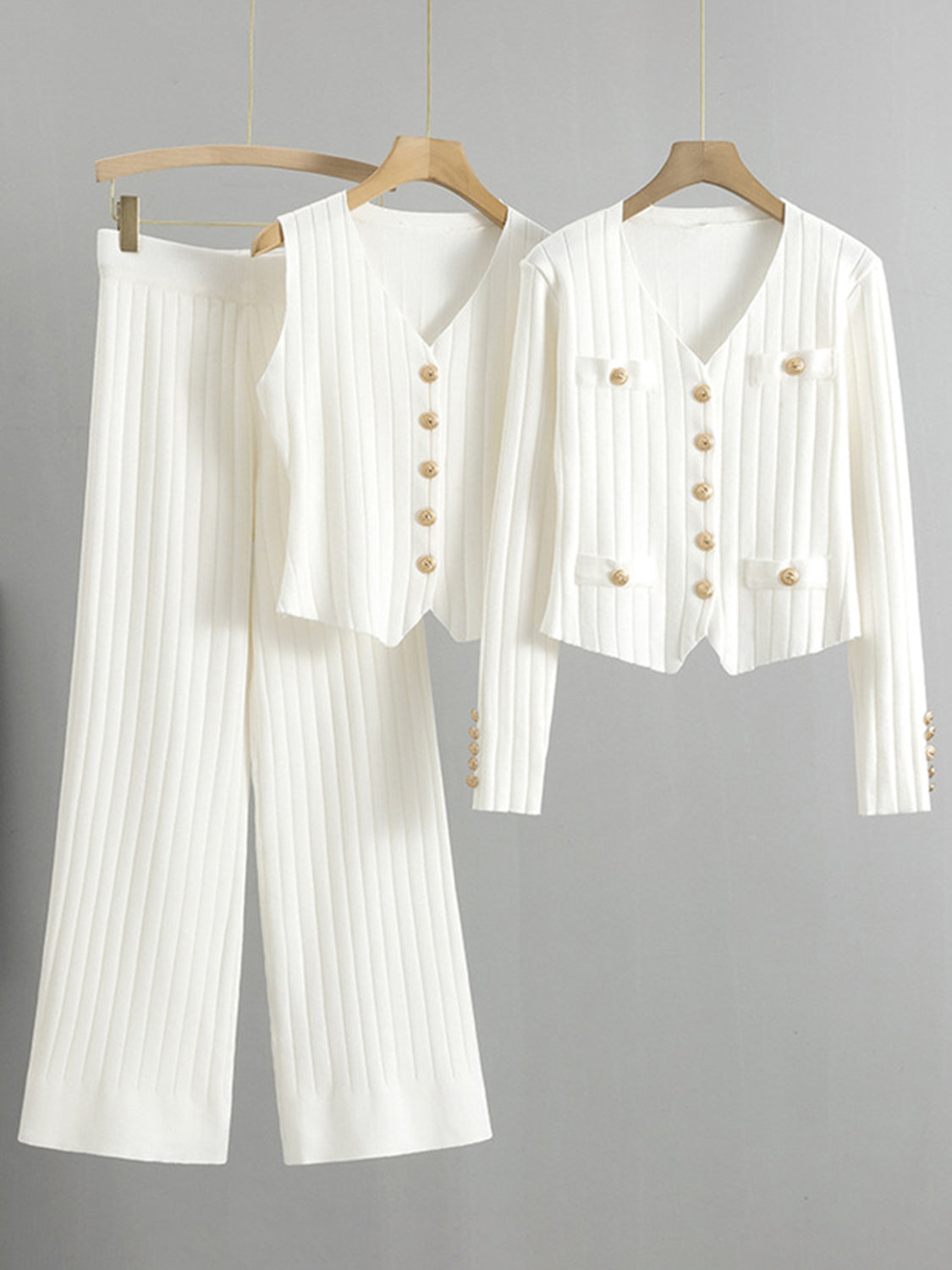 White ribbed knit outfit set with gold buttons, featuring a V-neck cardigan and wide-leg pants.