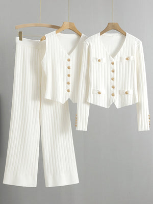White ribbed knit outfit set with gold buttons, featuring a V-neck cardigan and wide-leg pants.