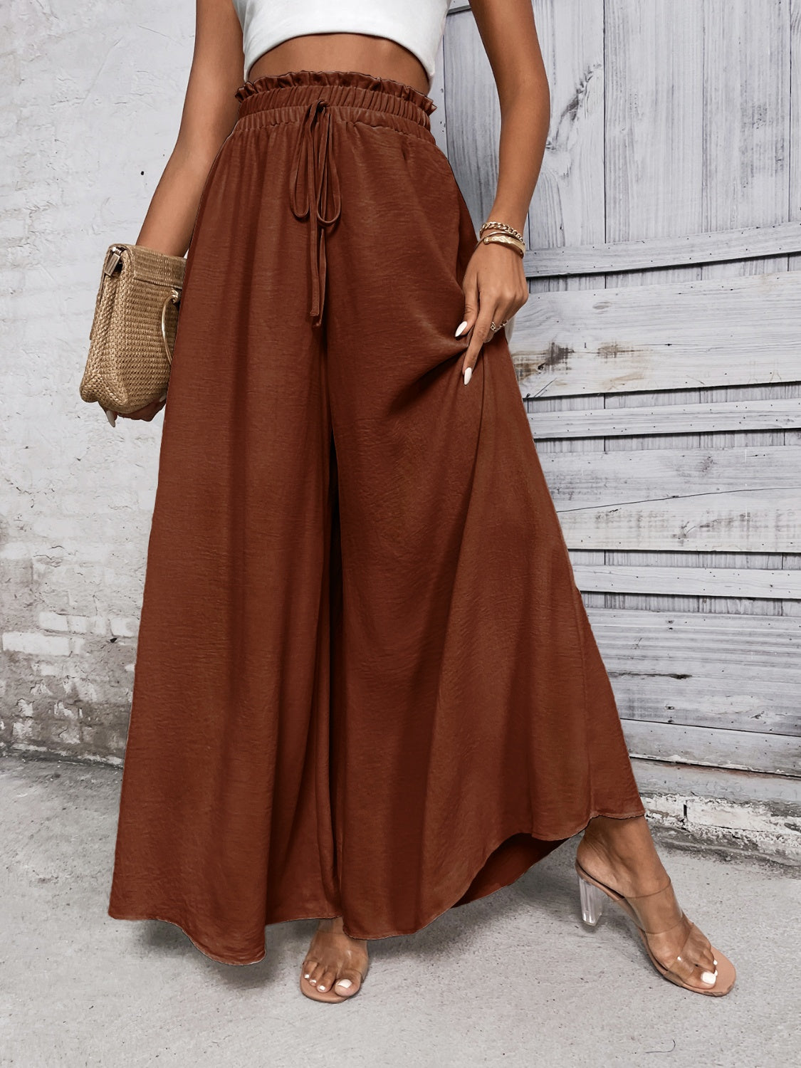 Brown ruffled waistline palazzo trousers with drawstring and wide legs.