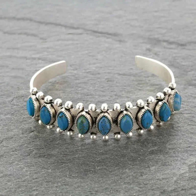 Turquoise cabochon open bangle bracelet with silver alloy detailing