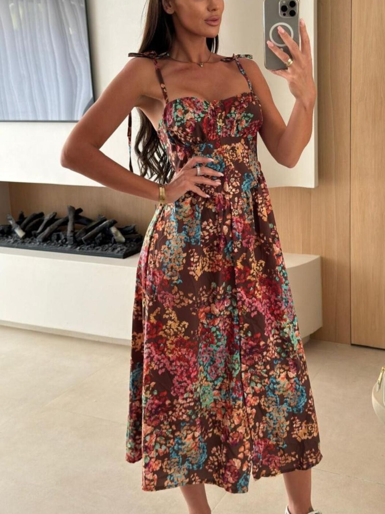 Tie-shoulder midi dress in brown with a colorful floral print and adjustable straps.