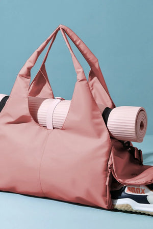 Dusty Pink duffel bag with a rolled yoga mat and a shoe visible in the side pocket.