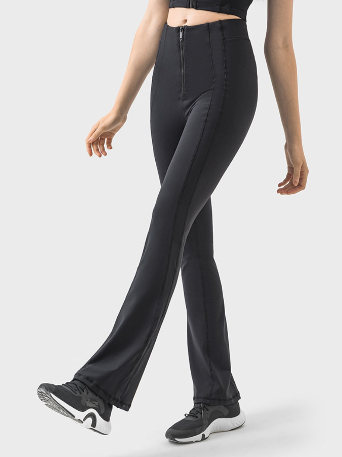 Black activewear pants with a zip front and flared leg