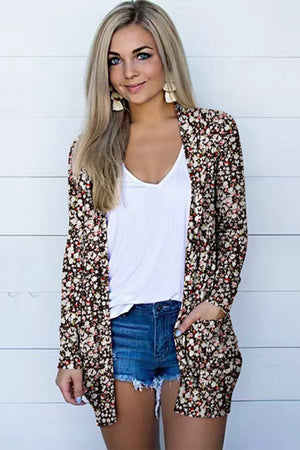 Floral print open-front duster cardigan with pockets, worn over a white v-neck top and denim shorts.
