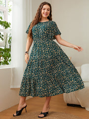 Emerald floral midi dress with tiered skirt and short sleeves.