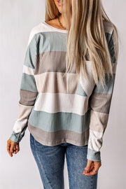 Ribbed stripe long sleeve top with patch pocket in neutral tones.