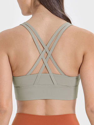 Sage green sports bra with crisscross back straps and wide band
