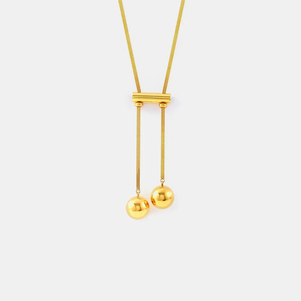 Gold lariat necklace with sphere drops and a bar detail