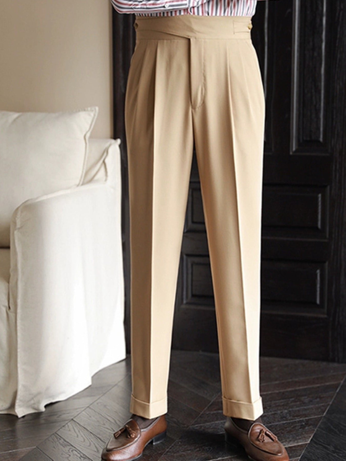 Khaki pleated wide-leg dress pants with cuffed hem and a tailored fit.