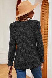 Black ribbed tee with puff sleeves and ruffled cuffs, square neck.