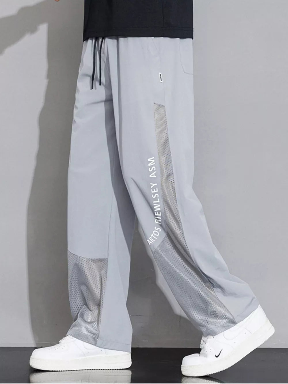 Light Gray sweatpants with mesh panels and wide-leg cut.