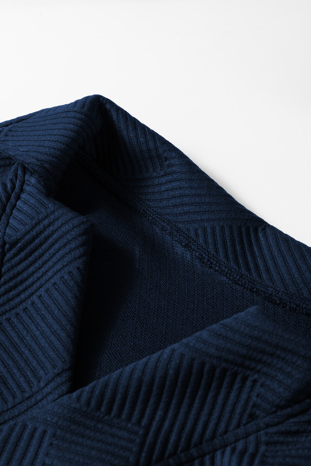 Navy textured polo set with wide-leg culottes, showing fabric detail.