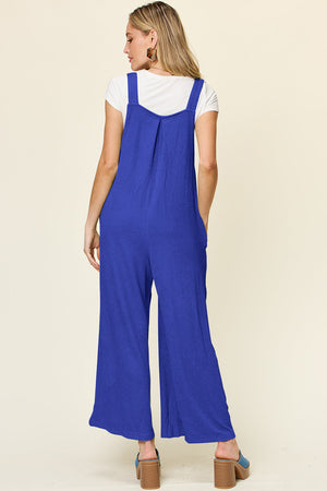 Ribbed Royal Blue wide-leg pinafore jumpsuit with pockets and a square neckline.