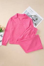 Hot pink quilted knit loungewear set with collared v-neck top and drawstring pants.