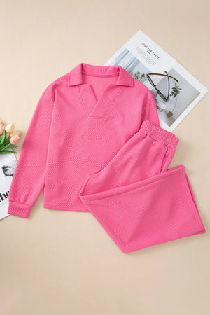 Hot pink quilted knit loungewear set with collared v-neck top and drawstring pants.