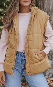 Tan padded sleeveless hooded vest with zipper and pockets.