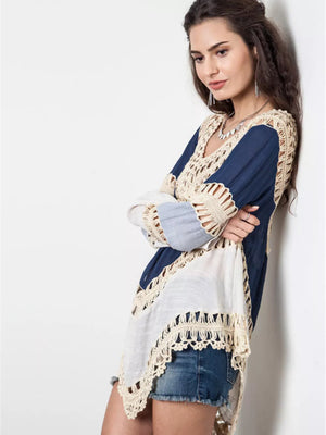 Blue and white long sleeve cardigan with crochet trim and cutout details.