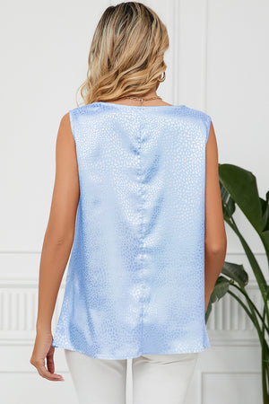 Light blue jacquard tank top with a subtle animal print texture and a draped neckline.