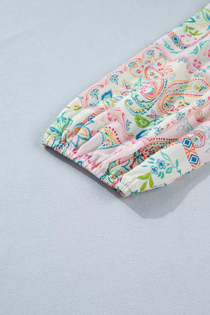 Floral patchwork mini dress with 3/4 elastic cuff sleeves and button-down detail.