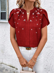 Rust embroidered floral keyhole blouse with flutter sleeves and a split neckline.